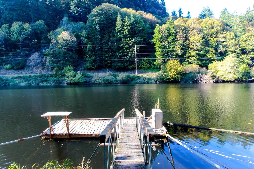 a dock in the middle of a lake at Alsea River Fishing Cabin in Waldport