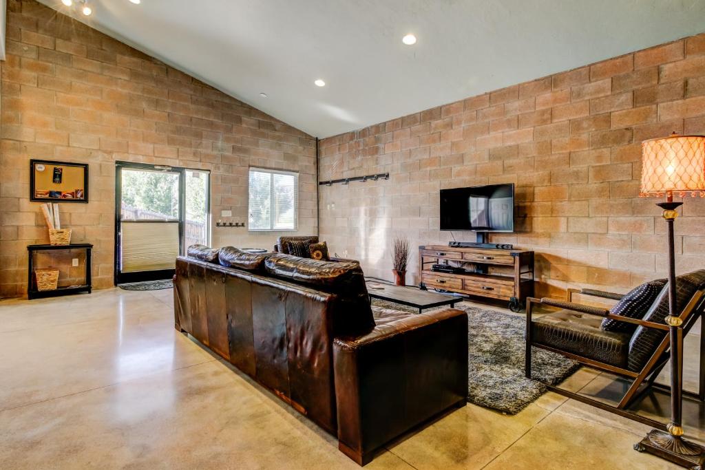 a living room with a couch and a tv at Bella Casa- Downstairs unit in Moab