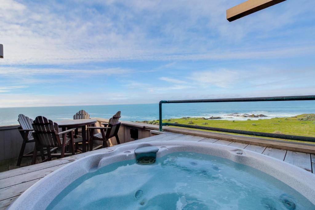a hot tub on a deck with a view of the ocean at Compass Rose in Sea Ranch