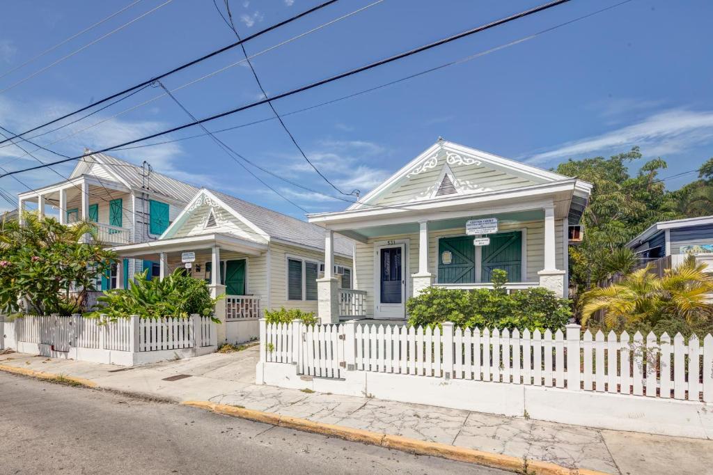 a row of houses with a white picket fence at Tradewinds in Key West