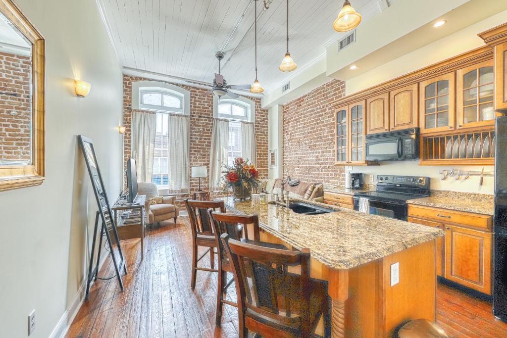 a kitchen with wooden cabinets and a counter top at Savannah Serendipity in Savannah