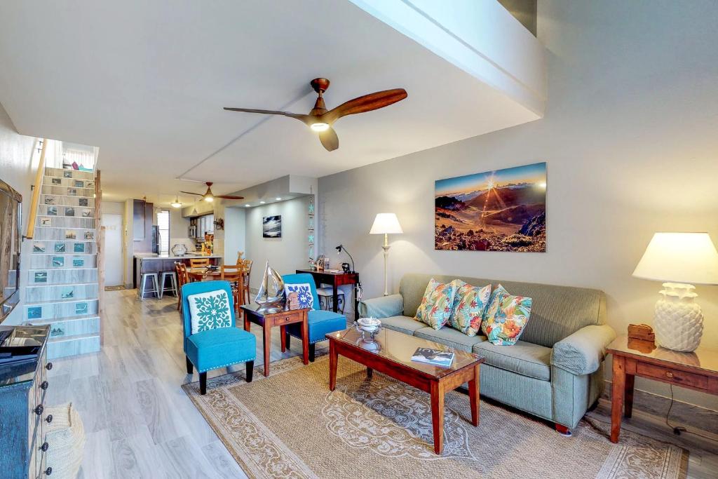 a living room with a couch and a table at Kahana Villa E610 in Kahana