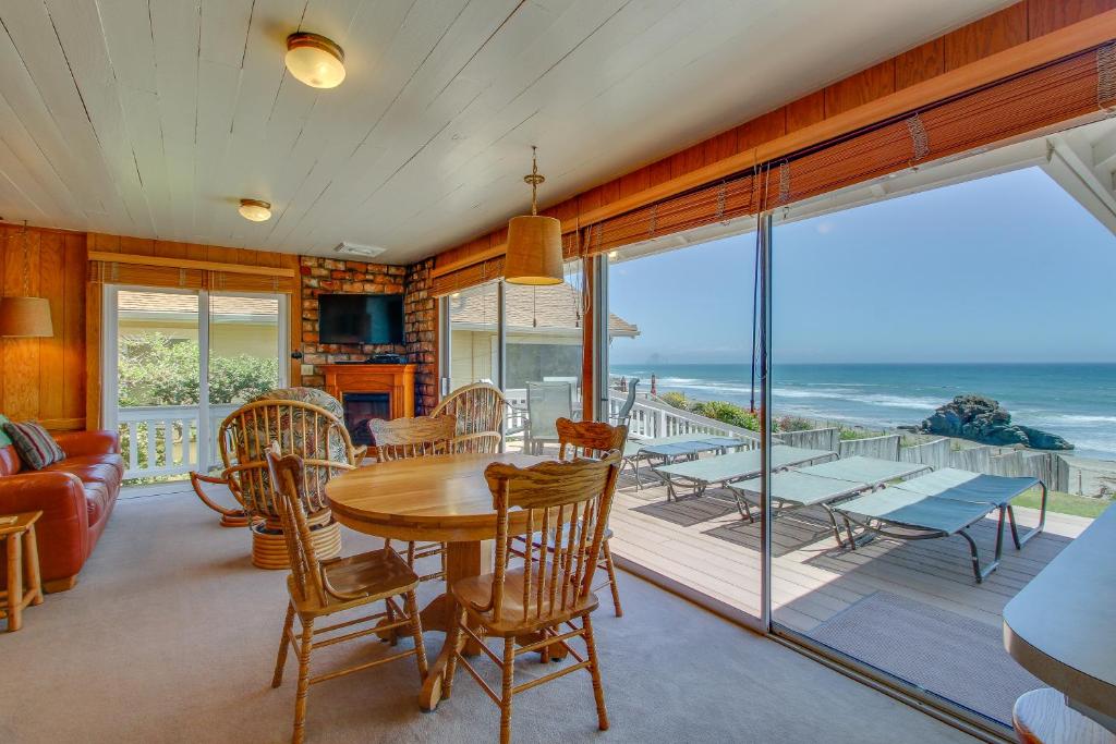 a dining room with a table and a view of the ocean at Coastal Coziness in Cayucos