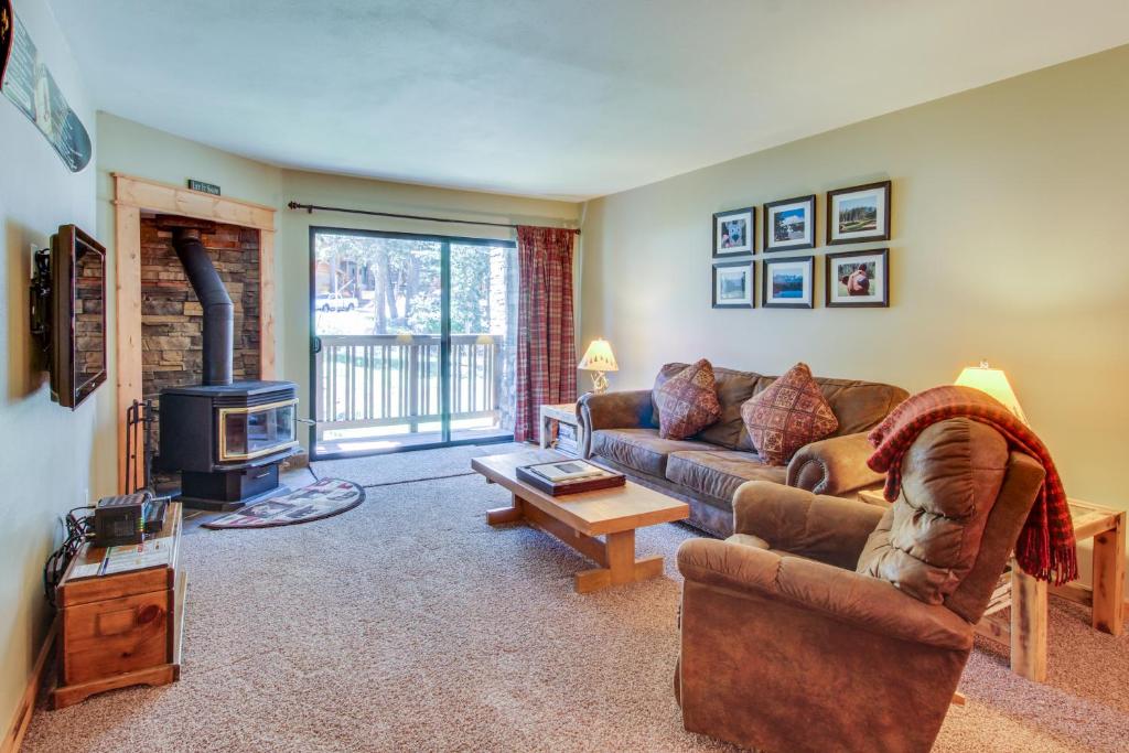 a living room with a couch and a fireplace at The Summit 206 in Old Mammoth