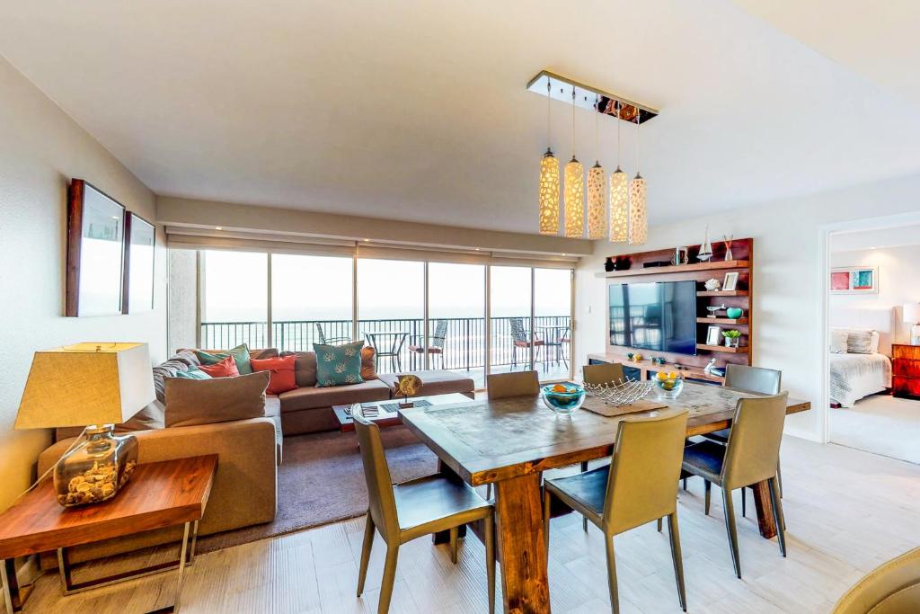 a living room with a table and a couch at Ocean Vista #1004 in South Padre Island