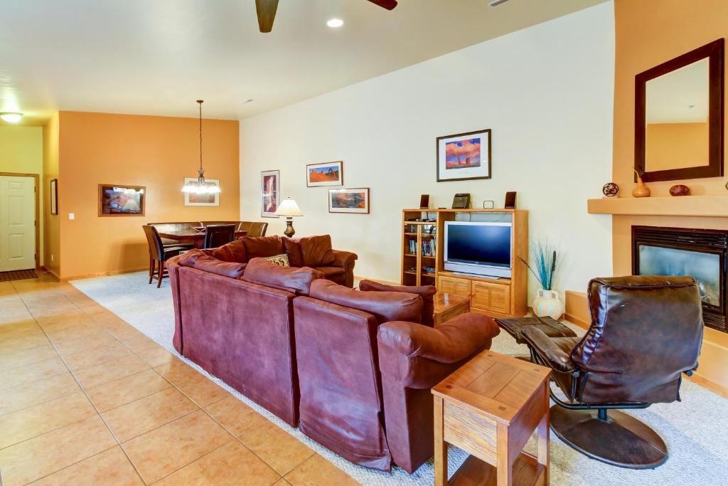 a living room with leather furniture and a fireplace at Cottonwoods 455 in Moab