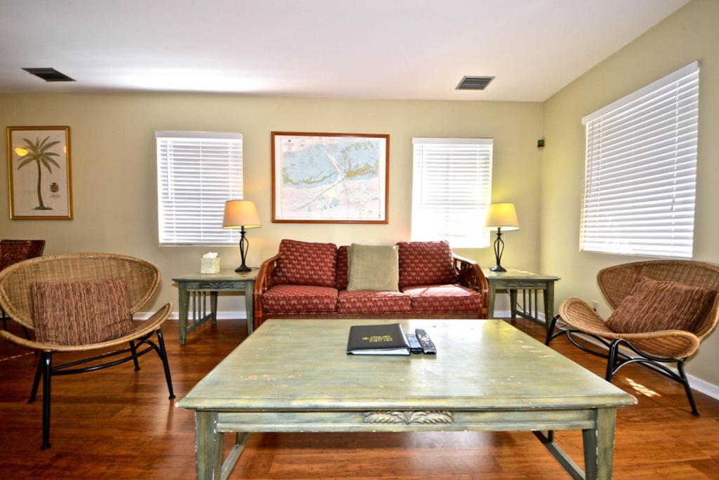 a living room with a couch and chairs and a table at Casa Havana @ Duval Square R22 in Key West