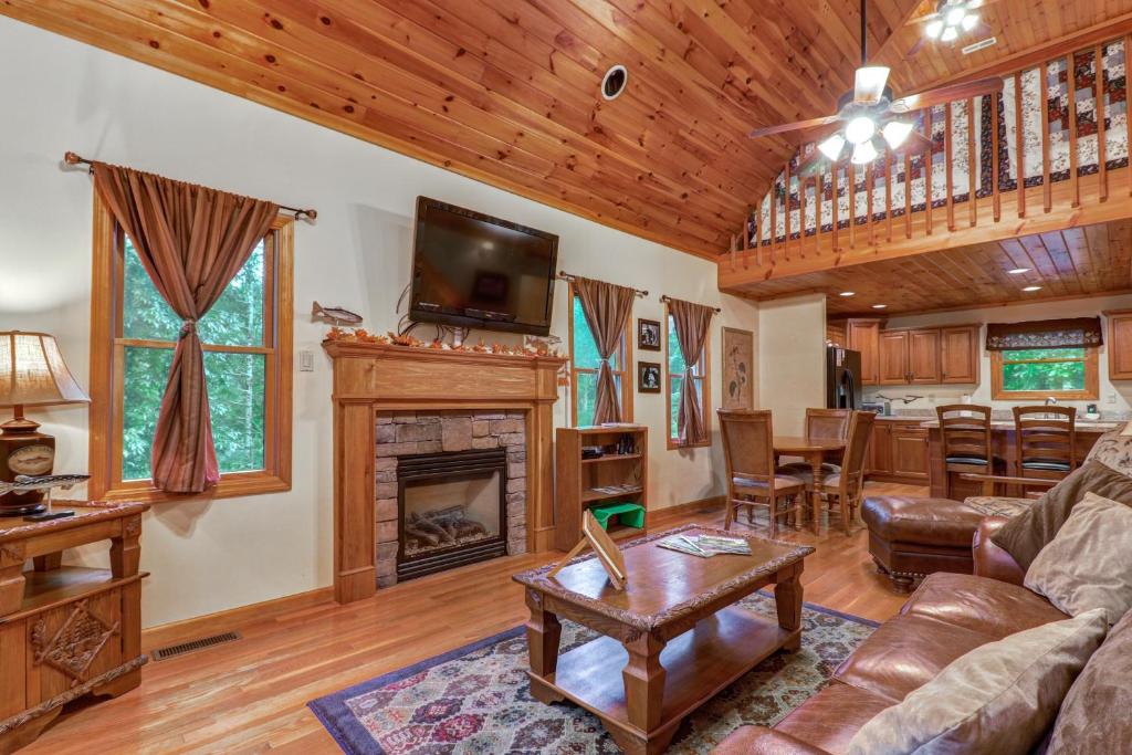 a living room with a couch and a fireplace at Cabin Fever in Townsend