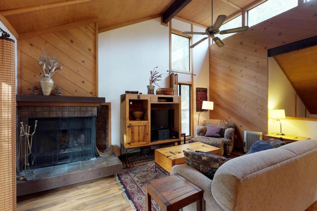 a living room with a fireplace and a couch at Shaver Haven Condominium in Shaver Lake