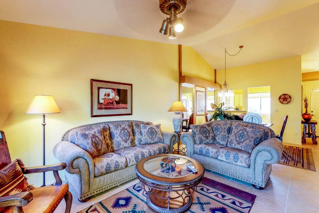 a living room with two couches and a table at Tucson National #2428 in Tucson