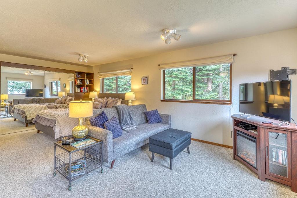 a living room with a couch and a tv at Osprey Nest in Coupeville