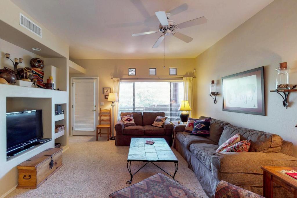 a living room with a couch and a flat screen tv at Rancho Vistoso #256 in Tortolita