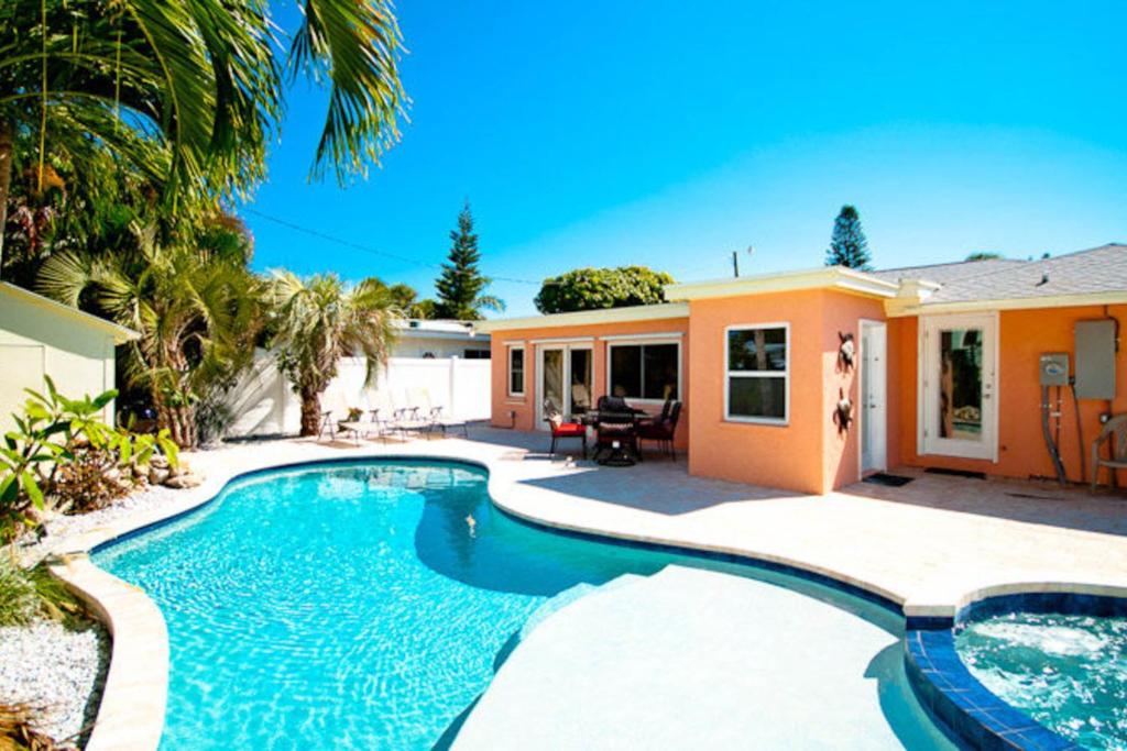 a swimming pool in front of a house at Tropical Oasis in Anna Maria