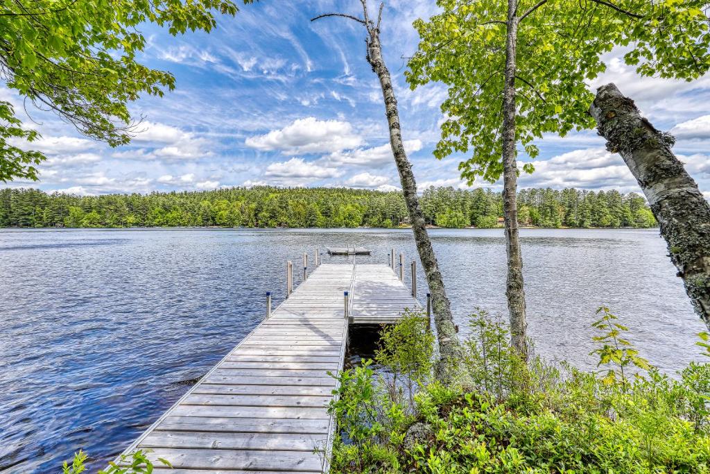a dock in the middle of a lake with trees at Private Contemporary in Chestertown