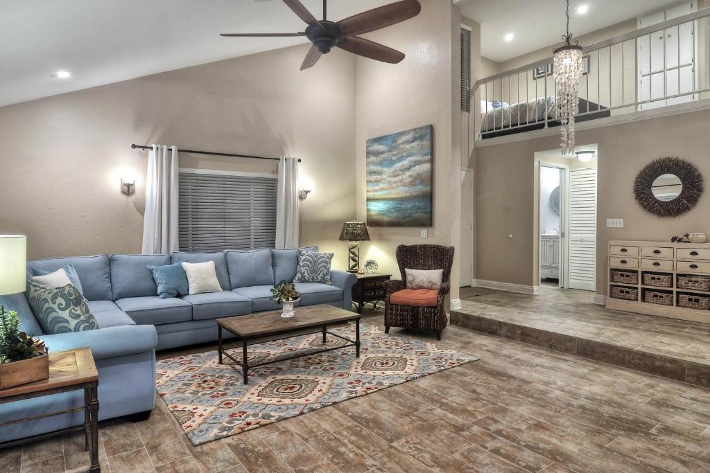 a living room with a blue couch and a ceiling fan at North Beach C in San Clemente