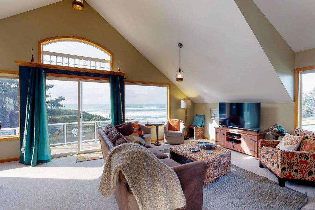 a living room with a view of the ocean at The Soaring Seabird in Yachats