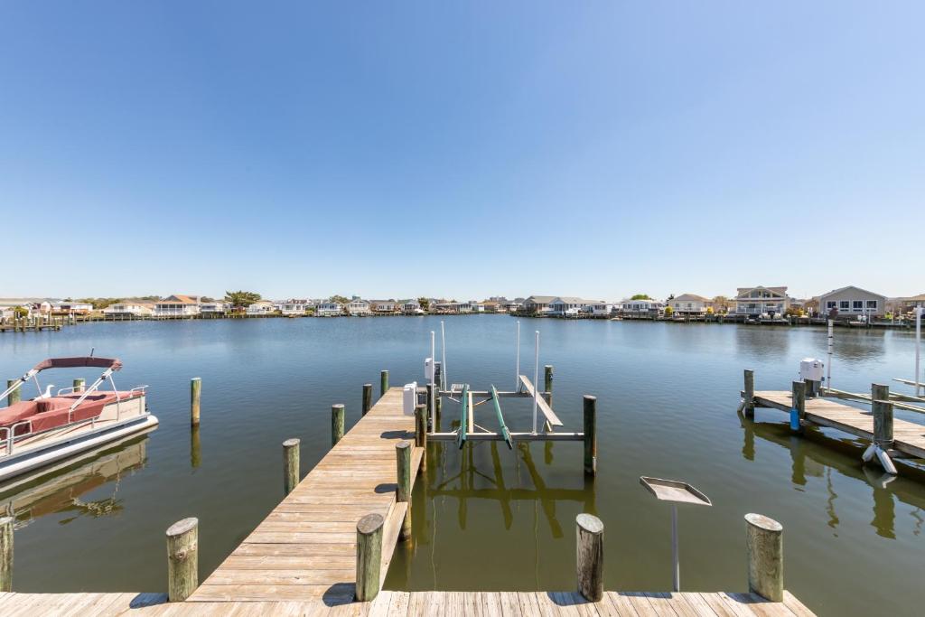 a dock with a boat on the water at Oyster Lane Hideout in Ocean City