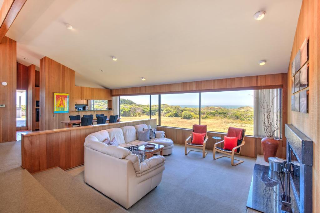 a living room with a couch and a table at Rolling Waves Beach House in Sea Ranch