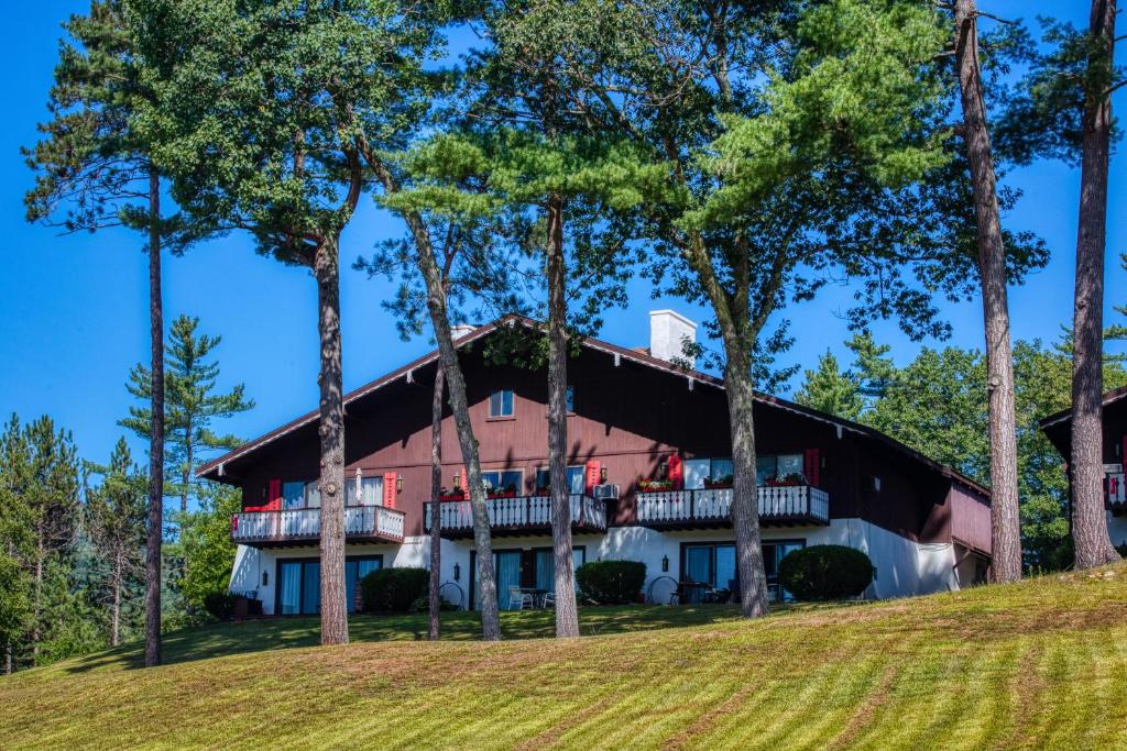 a large house on a hill with trees at Bunker Lane Golf Course in Bartlett