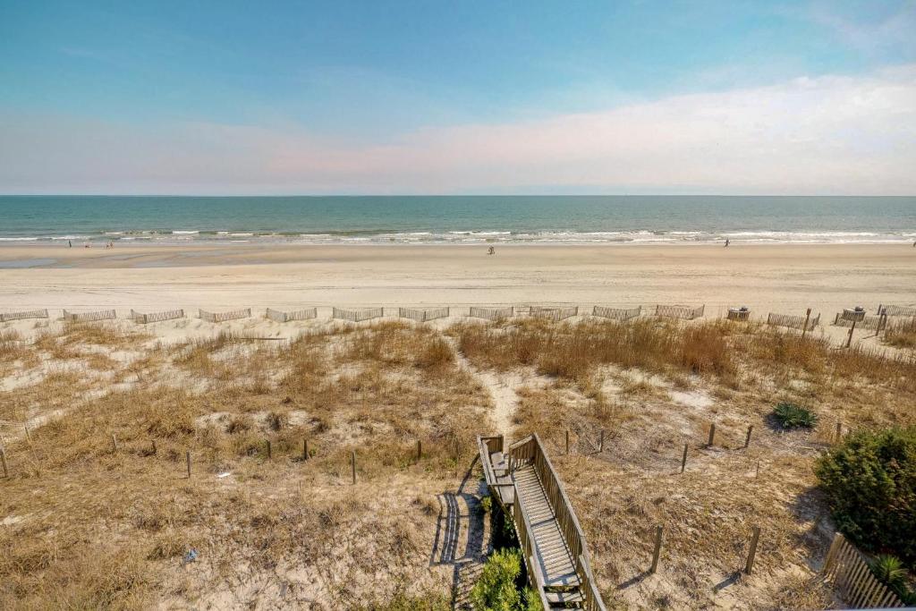 an empty beach with a staircase leading to the beach at Best Beach Spot in Myrtle Beach