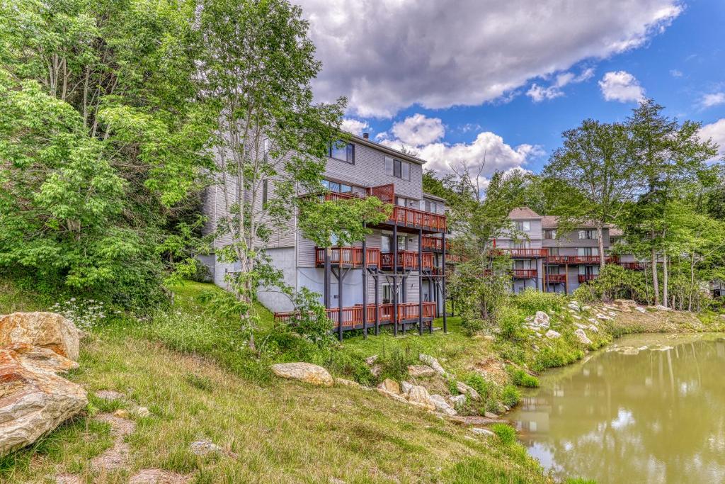 un immeuble situé à côté d'une étendue d'eau dans l'établissement Snowlake D-25, à Sugar Mountain