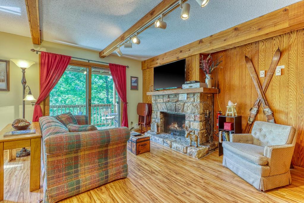 a living room with a couch and a fireplace at Bee Branch 44 in Sugar Mountain