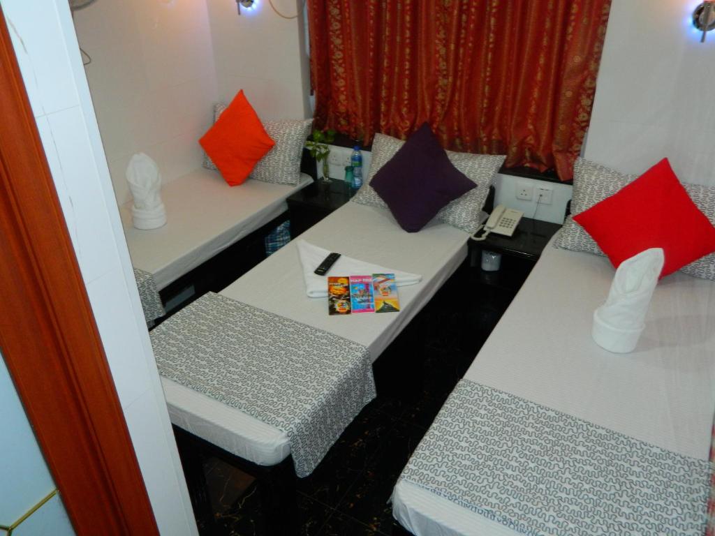 a room with two tables and two chairs with pillows at Marrigold Hostel in Hong Kong