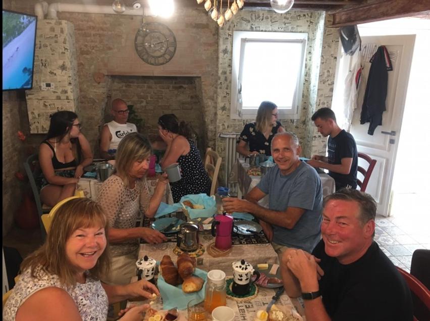 a group of people sitting around a table at Barbara’s rooms in Chioggia