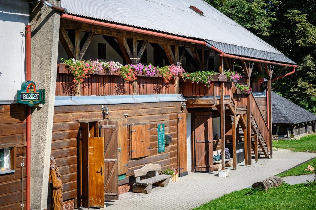 a building with a balcony with flowers on it at Penzion Tyra in Třinec