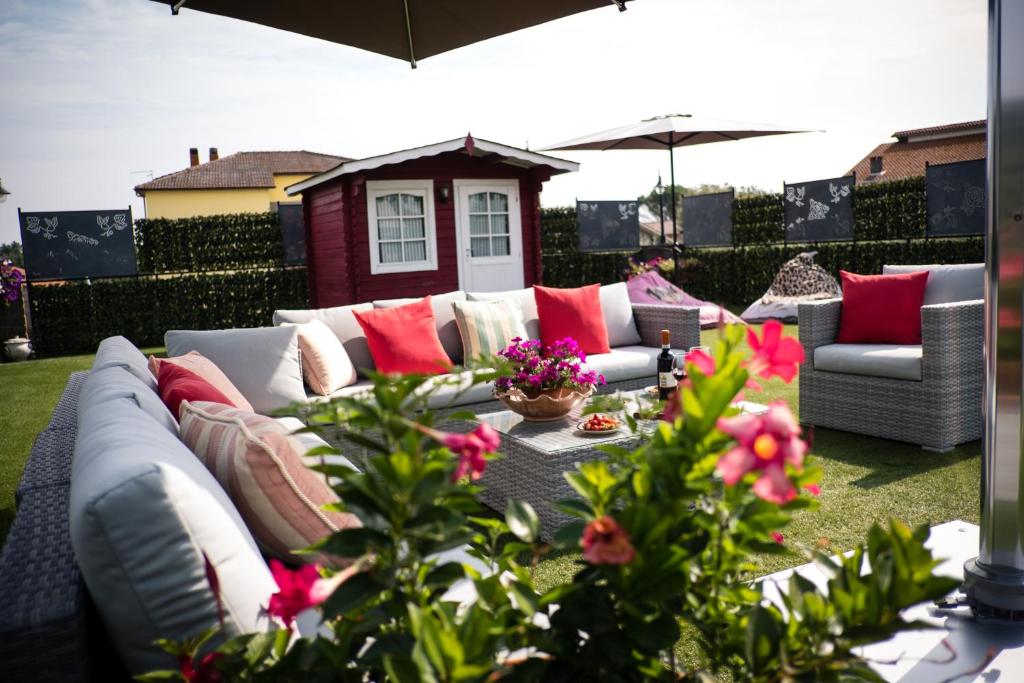 a white couch with red pillows on a patio at luxury evergreen terrace in Soriano nel Cimino