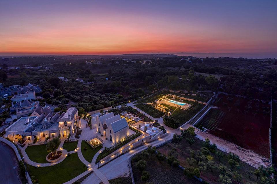 an aerial view of a mansion with a sunset at Ottolire Resort in Locorotondo