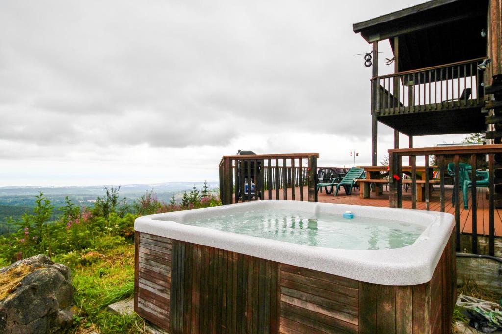 a hot tub on the side of a house at Port Angeles Blue Mountain Lodge with Bunkhouse in King Hill