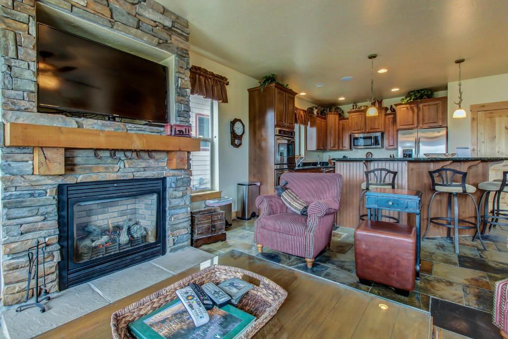 a living room with a fireplace and a tv at Spacious Bobsled House in Park City