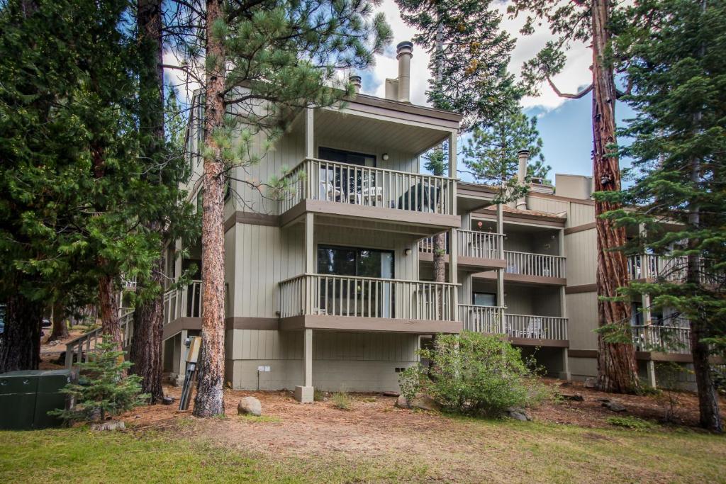 an apartment building with balconies in the woods at Nordic Retreat in Kings Beach
