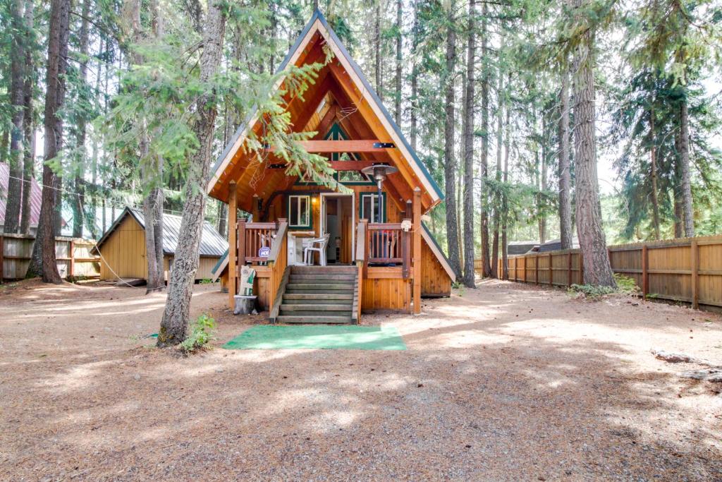 a small log cabin in the middle of a forest at Cabin in the Woods in Cabin Creek