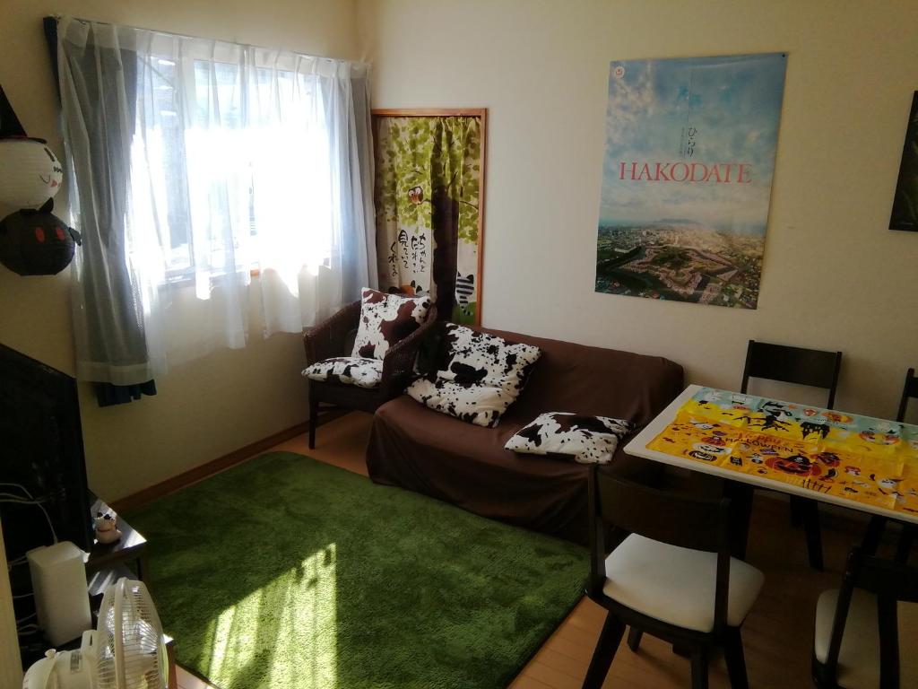 a living room with a couch and a table at Hakodate station 5minutes walk vacation stay in Hakodate