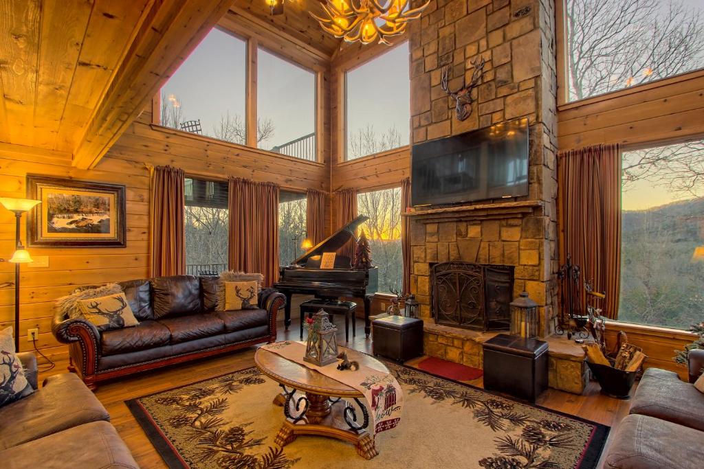 a living room with a couch and a fireplace at Soaring Eagle in Sautee Nacoochee