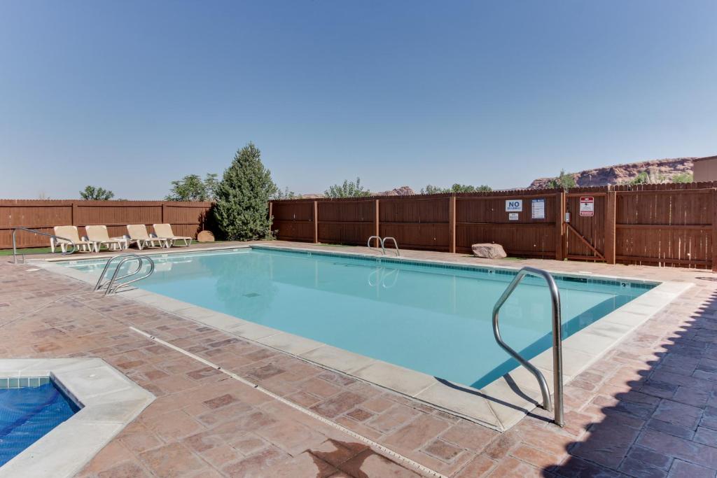 a large swimming pool with a fence at Rim Village O4 in Moab