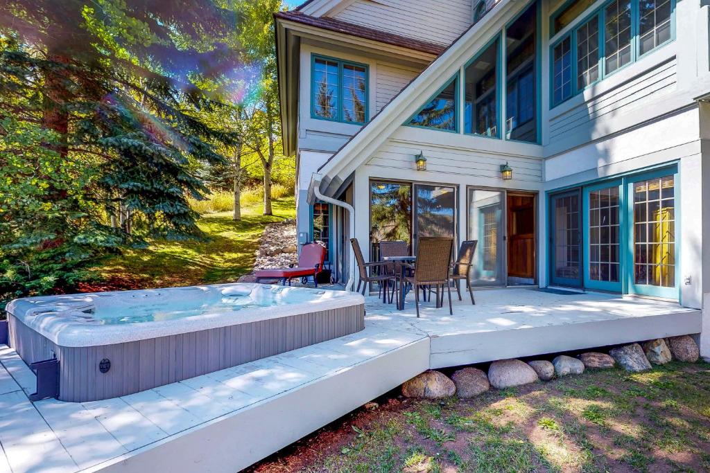 a house with a hot tub on a patio at Wayne Creek Residence in Avon