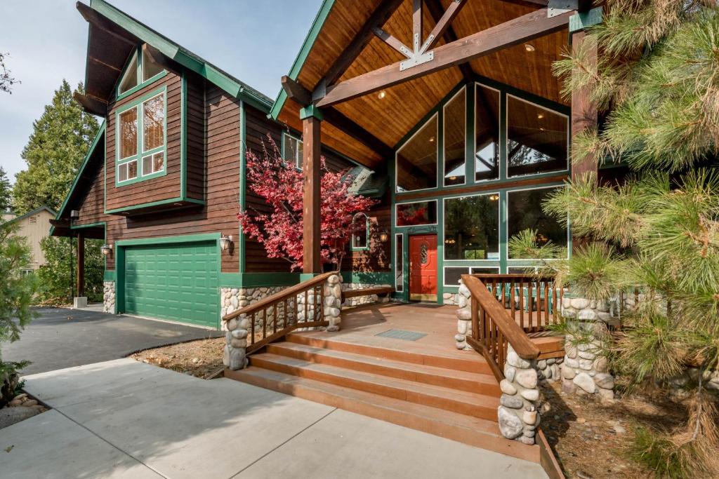 a home with a green garage door and a house at Handel's Pride in Shaver Lake