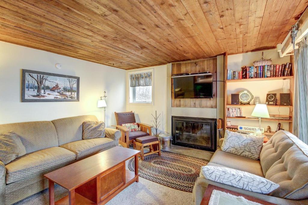 a living room with a couch and a fireplace at Okemo Trailside 08E in Ludlow