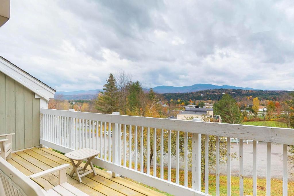 a balcony with a chair and a view of the mountains at Mountainside resort H201 in Stowe