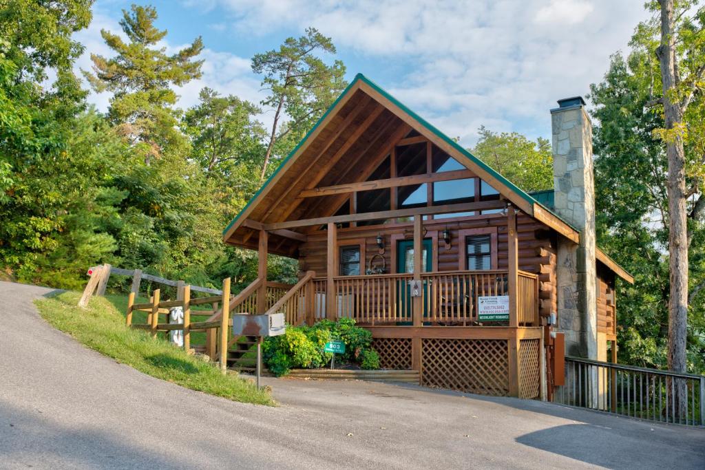 a cabin in the woods with a driveway at Moonlight Romance in Pigeon Forge