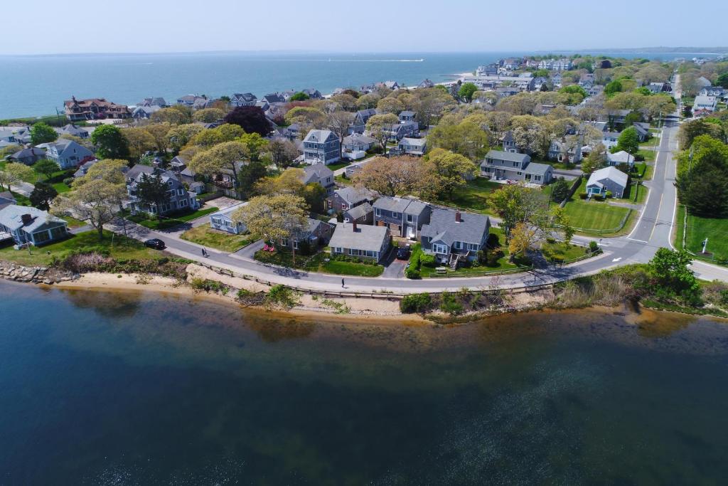an aerial view of a neighborhood with houses and the water at SEA-esta in Falmouth