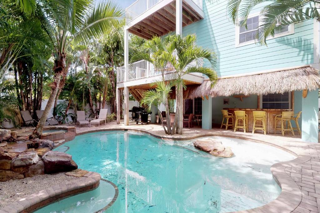 a swimming pool in front of a house at Almost Gulf Front in Holmes Beach