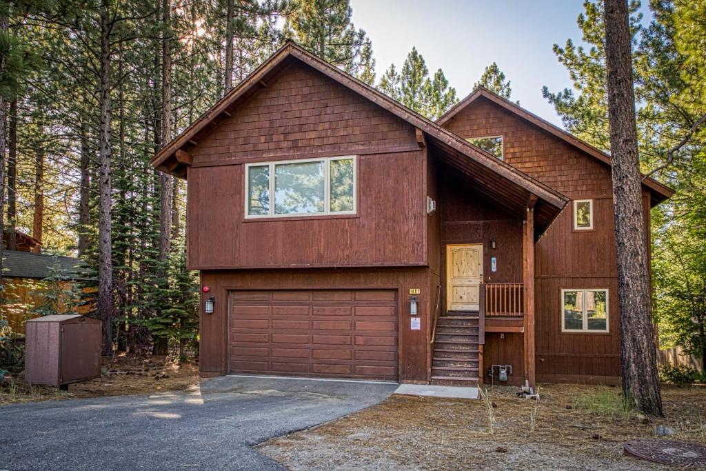 a house with a garage in the woods at Elegant Pine in South Lake Tahoe
