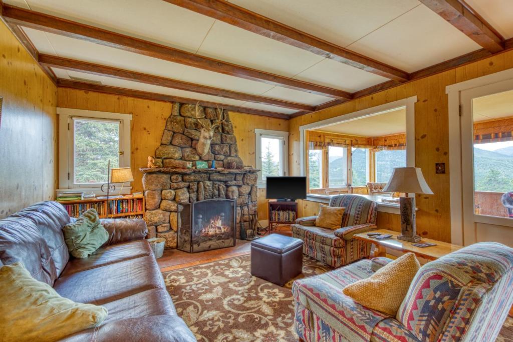 a living room with a couch and a fireplace at Longs Peak Cabin in Estes Park