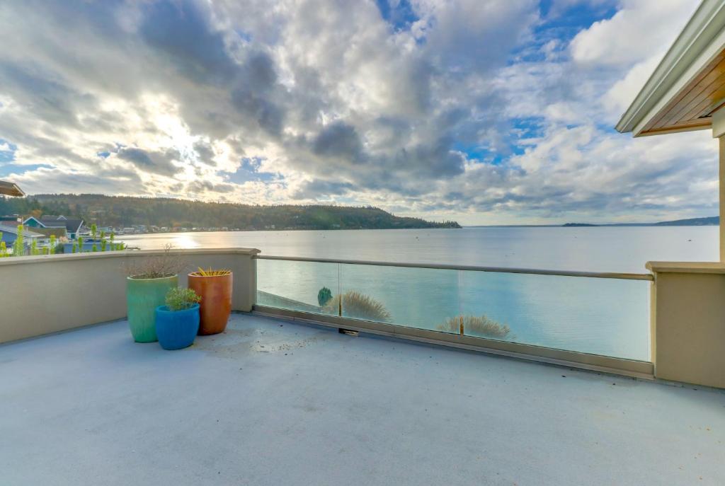 a balcony with a view of the water at Camano Island Waterfront Modern Splendor in Lona Beach