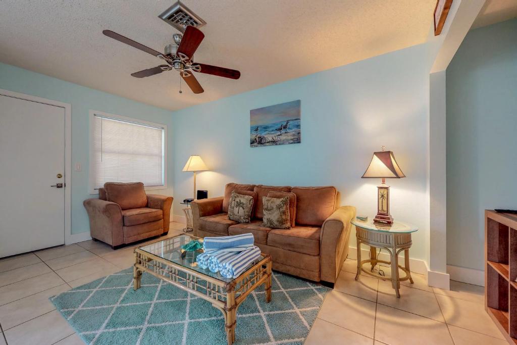 a living room with two couches and a ceiling fan at Highland Avenue Heaven in Bradenton Beach