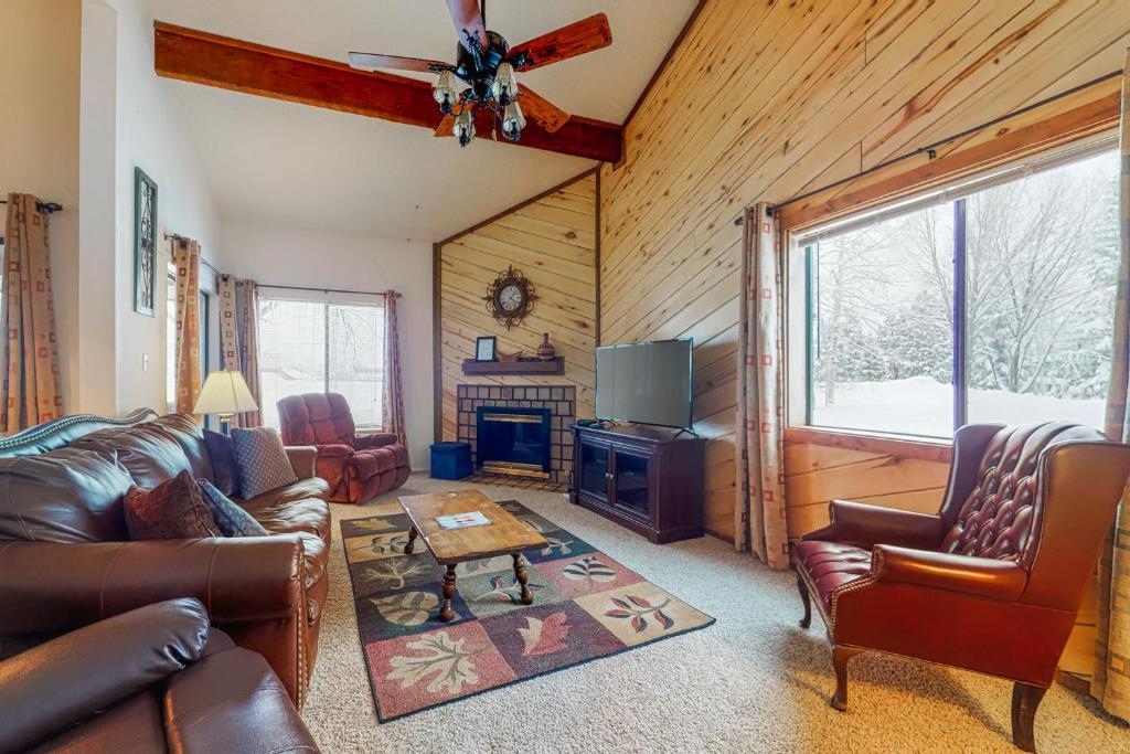 a living room with a couch and a tv and a table at Pines 4058 in Pagosa Springs